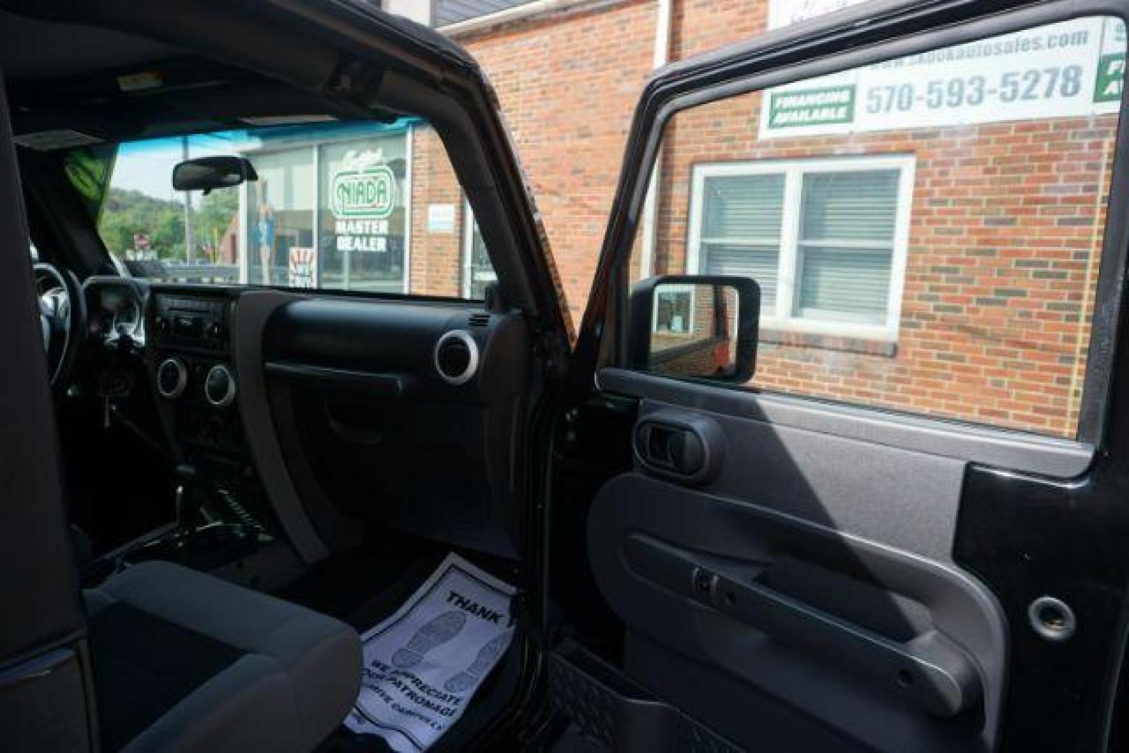 2010 Black Clearcoat/Black Soft Top /Dark Khaki/Medium Khaki Jeep Wrangler Sahara (1J4GA5D10AL) with an 3.8L V-6 regular unleaded engine, located at 312 Centre Ave, Schuylkill Haven, PA, 17972, (570) 593-5278, 40.638130, -76.177383 - Photo#29