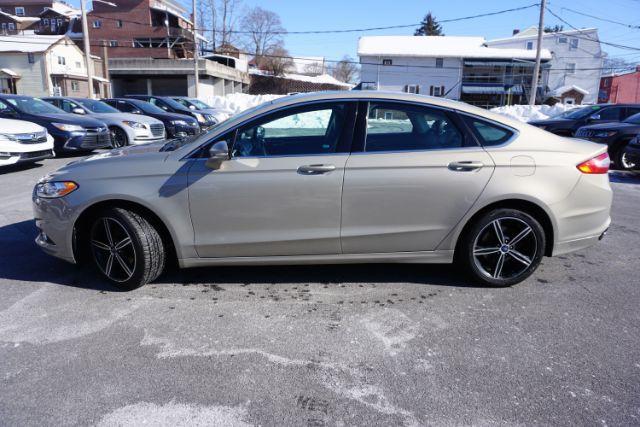 2015 Bronze Fire Metallic Tinted Clearcoat /Ebony Ford Fusion SE (3FA6P0T95FR) with an EcoBoost 2L I-4 gasoline direct injection engine, located at 312 Centre Ave, Schuylkill Haven, PA, 17972, (570) 593-5278, 40.638130, -76.177383 - Photo#0